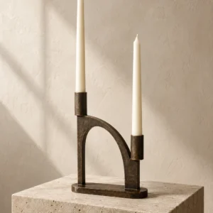 Arc aged-bronze candle holder with two ivory taper candles