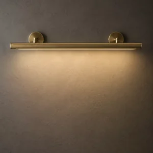 Halo slender aged brass picture light casting a warm even wall wash